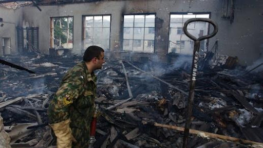 A fireman investigates a gym during the rescue operation at Beslan school, North Ossetia
